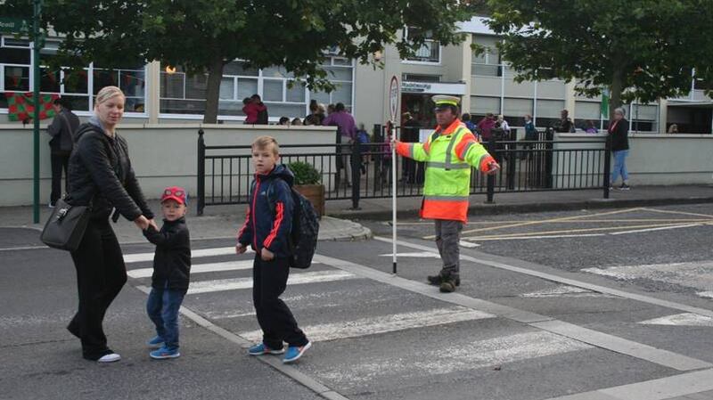 Traffic warden Henry Brawn provides a safe crossing with the “lolli-cop” sign at Scoil Padraic, Westport, Co Mayo