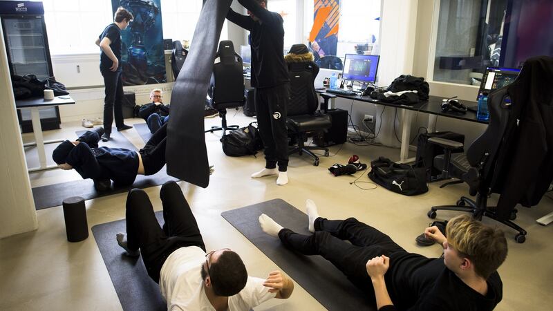 Team Origen stretches in the training room following a scrimmage against another team at Rfrsh Entertainment’s offices in Copenhagen. Photograph: Pete Kiehart/ The New York Times