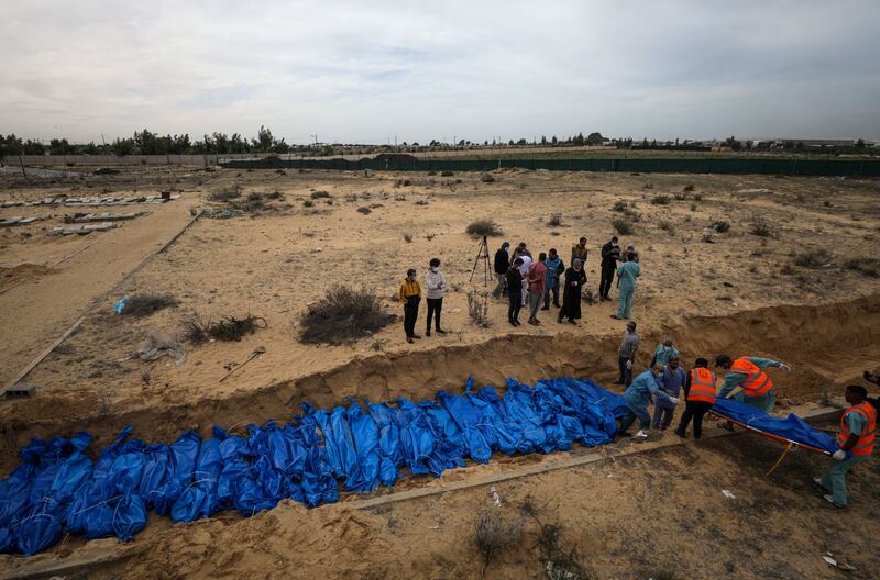 Palestinians bury the bodies of 111 people killed in Israeli strikes on Gaza, in a mass grave at the Khan Younis cemetery in the southern Gaza Strip on Wednesday. Photograph: Mohammed Saber/EPA-EFE