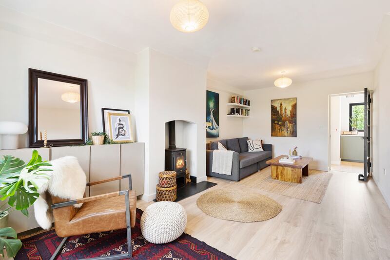 The livingroom has a stove and opens to the kitchen at the rear