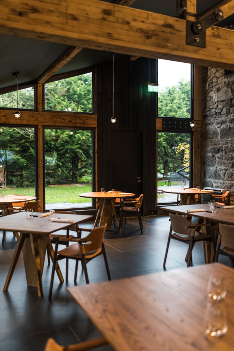 The kitchen is behind a wall when you enter the dining room. The drama is the landscape outside. Photograph: Julia Dunin