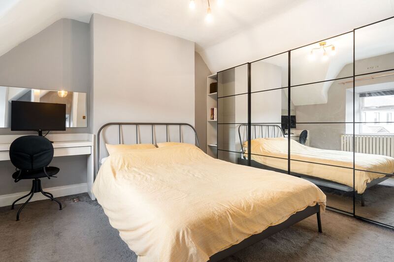 Upstairs, the main bedroom sits to the rear with a wall of sliding, mirrored, built-in wardrobes. 