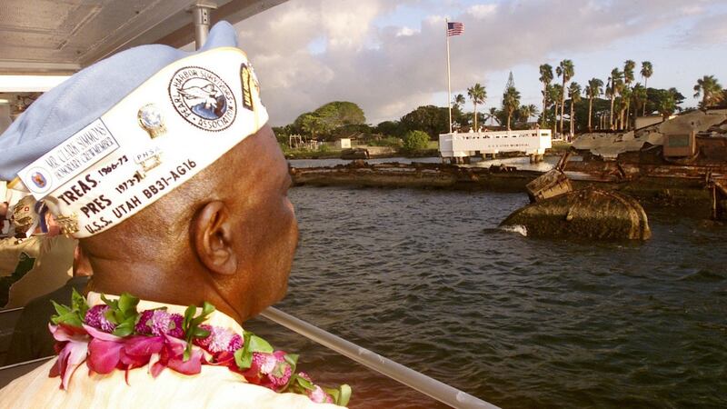 Navy veteran Clark Simmons (80) looks over the rusting hulk of his old ship, the USS Utah, during ceremonies marking the 60th anniversary of the Japanese attack on Pearl Harbor, December 6th, 2001. Photograph: Ronen Zilberman/AP