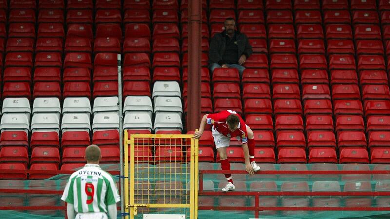 Shelbourne’s Niall O’Reilly retreives the ball from the empty stands with John O’Flynn of Cork looking on during an FAI Cup match in 2007. Photo: Cathal Noonan