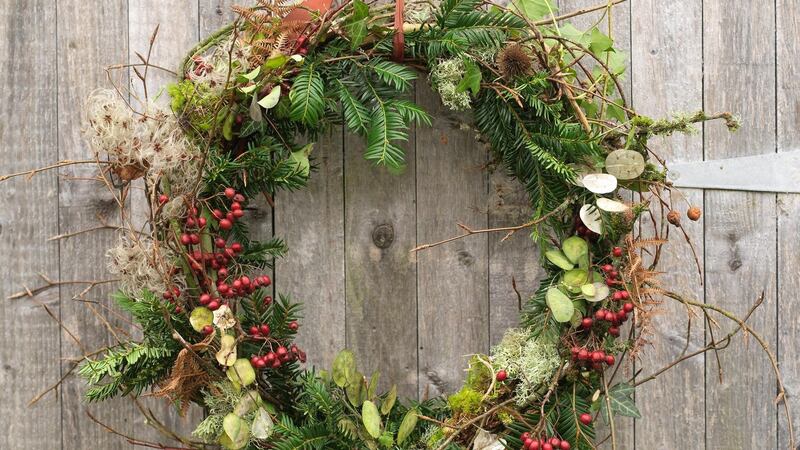 Close-up of a natural Christmas wreath made by Fionnuala Fallon, using willow, yew, honesty seedheads, hawthorn berries, ferns, beech twigs and old man's beard foraged from the garden or in the wild