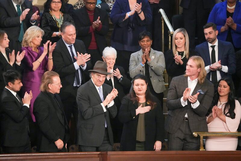 Oksana Markarova, Ambassador of Ukraine to the United States, holding her hand over her heart; next to Paul Pelosi, Bono, and Bradley Tsay during US president Joe Biden's State of the Union address. Photograph: Haiyun Jiang/The New York Times
