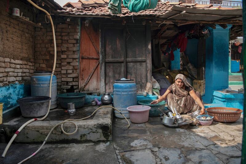 A woman washes utensils using tap water in Panari, India. Photograph: Saumya Khandelwal/The New York Times