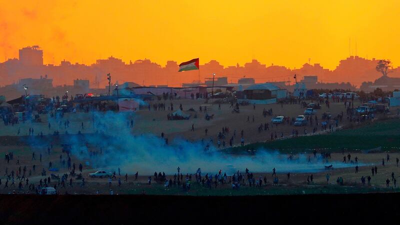 Tear gas fumes rise amid Palestinian protesters along the Gaza Strip border on Tuesday in a photograph taken from  the southern Israeli kibbutz of Nahal Oz. Photograph: Jack Guez/AFP/Getty Images