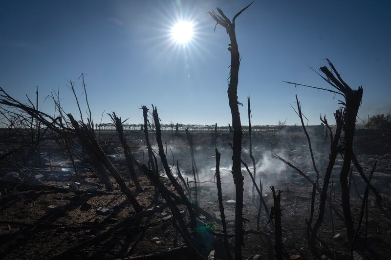 Smoke rises from the ruins of a private farm and still-burning granary after a recent Russian rocket attack in the village of Kiseliovka close to Kherson. Photograph: AP