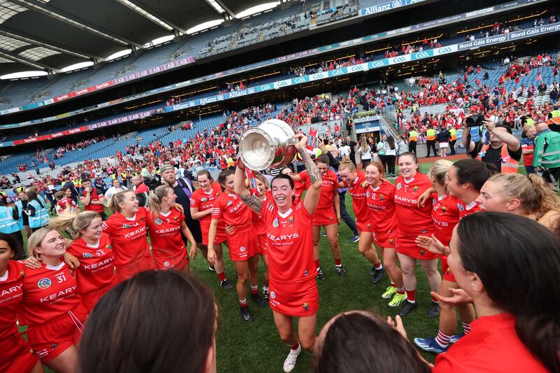 Cork's Ashling Thompson celebrates with the cup and her team-mates at Croke Park. Photograph: Bryan Keane/Inpho