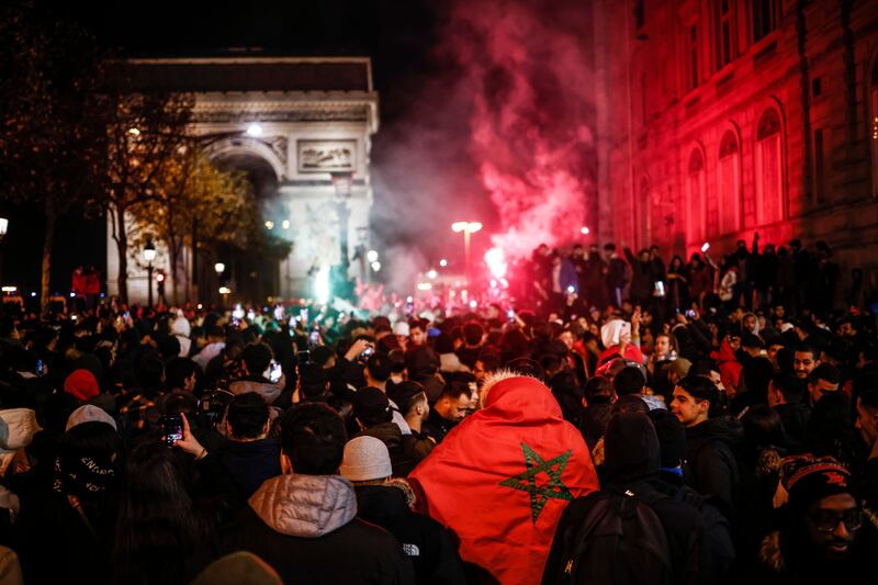 Moroccan supporters celebrate their team winning the FIFA World Cup 2022 round of 16 soccer match between Morocco and Spain, on the Champs Elysees avenue in Paris, France. Photograph: Yoan Valat/EPA