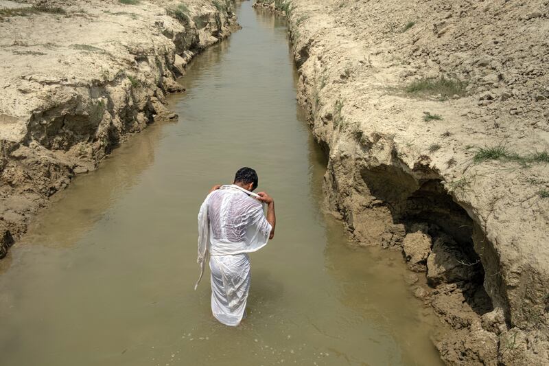 Ram Bikash, Rakesh Kumar Yadav’s oldest son, after he had gathered his father’s ashes three days after his cremation, in Dhamaura, Nepal. Photograph: Saumya Khandelwal/New York Times