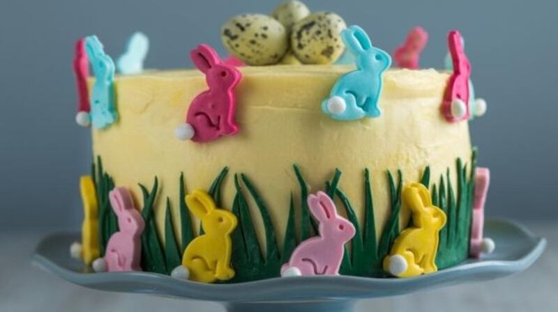 Easter bunnies on a three-layer sponge cake with passionfruit icing.
