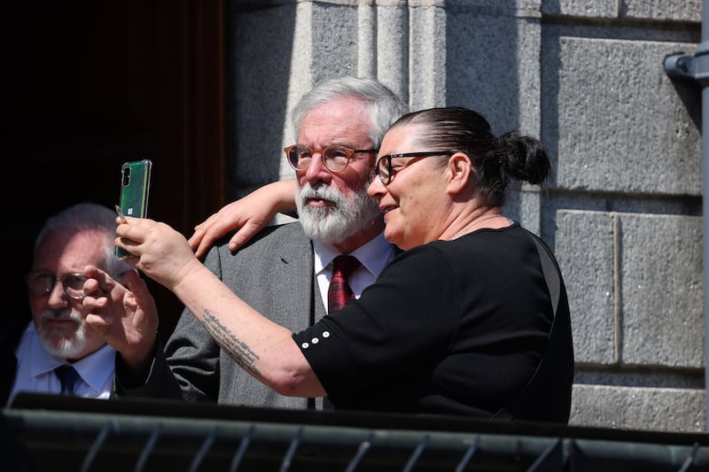 Gerry Adams poses for a selfie while leaving the High Court. Photograph: Dara Mac Dónaill