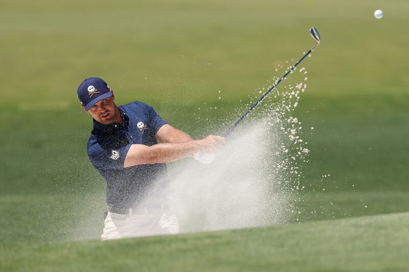 Bryson DeChambeau plays a shot from a bunker on the practice area prior to the final round at Augusta. Photograph:  Richard Heathcote/Getty Images