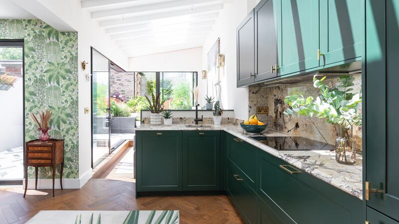 The open-plan kitchen diner features dramatic quartz countertop