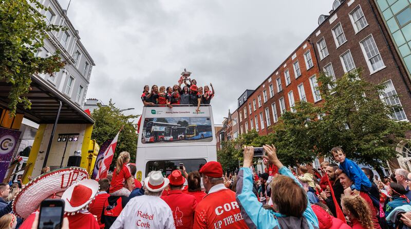 The victorious Cork team greeted by fans as they arrive at The Imperial Hotel following the open bus trip through the city centre. Photograph: James Crombie/Inpho 