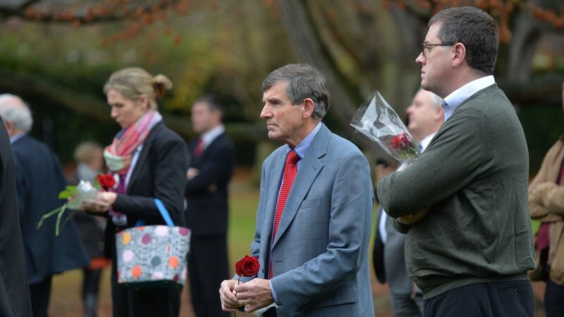 Michael Deely, father of disappeared Trevor Deely, throwing a rose into the pond at Farmleigh during the fourth missing persons ceremony. Photograph: Alan Betson