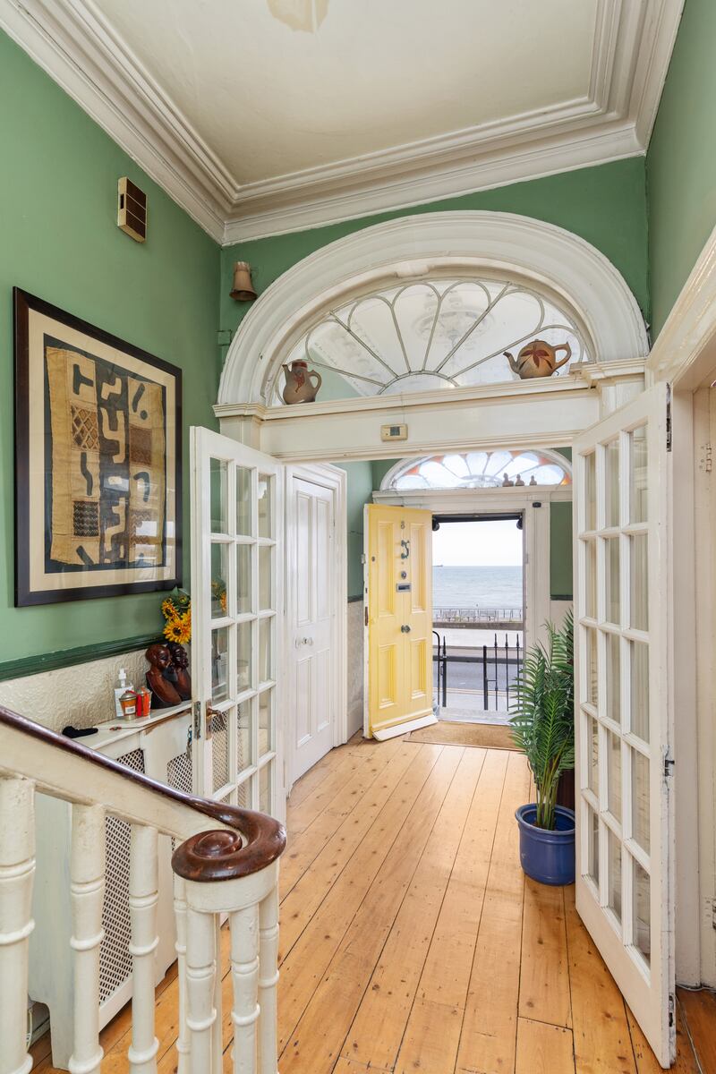 The house retains period details such as an inner fanlight and detailed cornicing