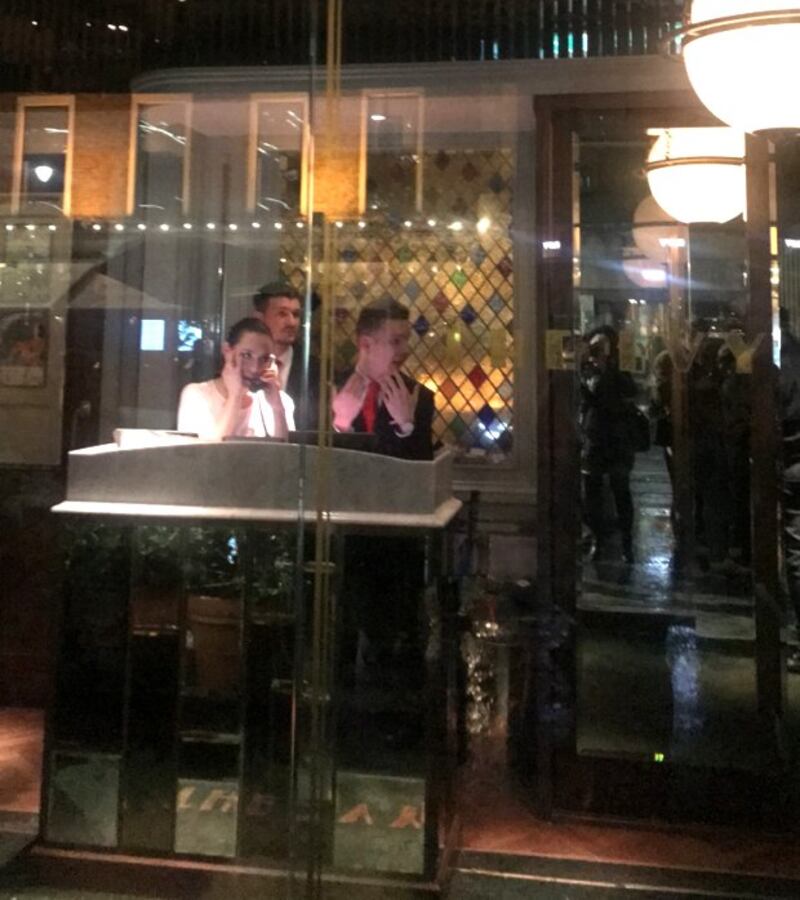 Staff inside The Ivy restaurant on Thursday night as a protest took place outside. Photograph: Áine McMahon