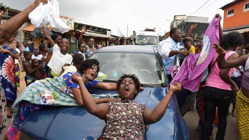 People celebrate on the streets in Abidjan’s working class district of Yopougon after the International Criminal Court acquitted the former Ivory Coast president Laurent Gbagbo. Photograph: Issouf Sanogo/AFP/Getty Images