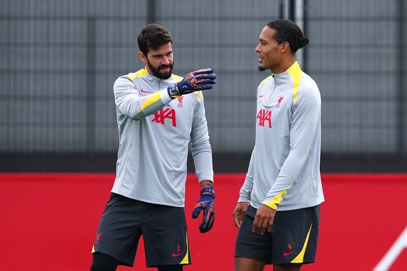 Liverpool's Virgil van Dijk and Alisson Becker during training before Tuesday's Champions League meeting with AC Milan. Photograph:  Peter Byrne/PA Wire