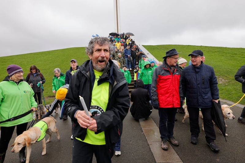 Charlie Bird leading supporters from Pieta, the Irish Motor Neurone Disease Association, Samaritans, Vicky Phelan's family members and friends, Irish Guide Dogs for the Blind, Defence Forces, Dogs Trust, frontline workers, Stardust families, Irish Wheelchair Association, and members of the LGBTQ+ community, over the Papal Cross mound in the Phoenix Park at the start of a 5K walk in Phoenix Park, to mark the first anniversary of Climb with Charlie. Photograph: Alan Betson

