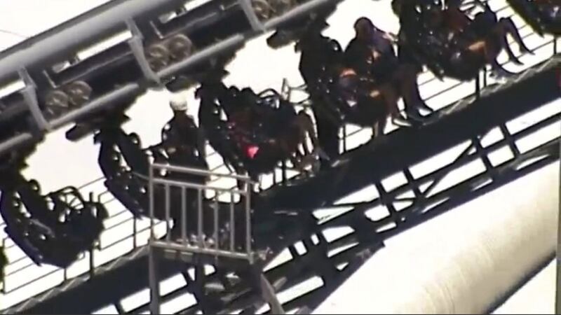 Rescue help  people stuck in the Arkham Asylum roller coaster ride. Photograph: Reuters