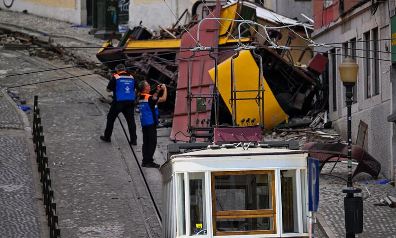 Authorities inspect the area surrounding the wrecked Glória Funicular crash in Lisbon. Photograph: Horacio Villalobos/Getty Images