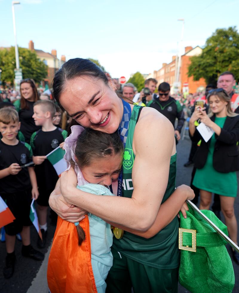 Kellie Harrington hugs 9-year-old Maisie Farrell during her homecoming on Sean McDermott street in Dublin, after returning from the Paris 2024 Olympic Games. Photograph: Niall Carson/PA