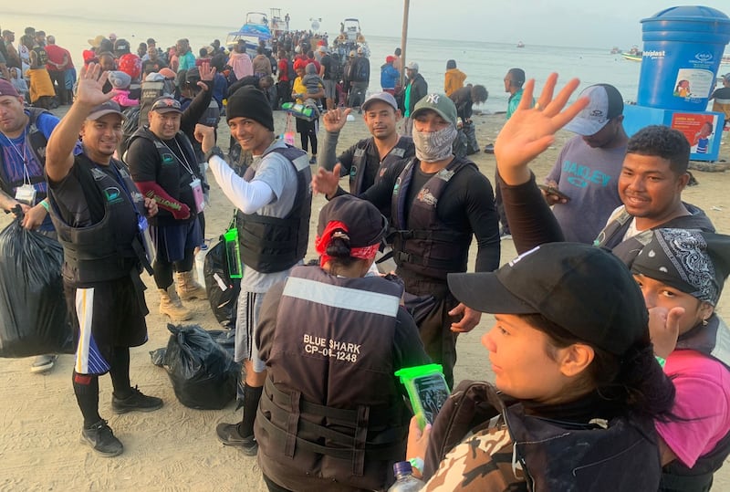 Migrants queueing and boarding ferries in Necoclí. Photograph: Peter Murtagh