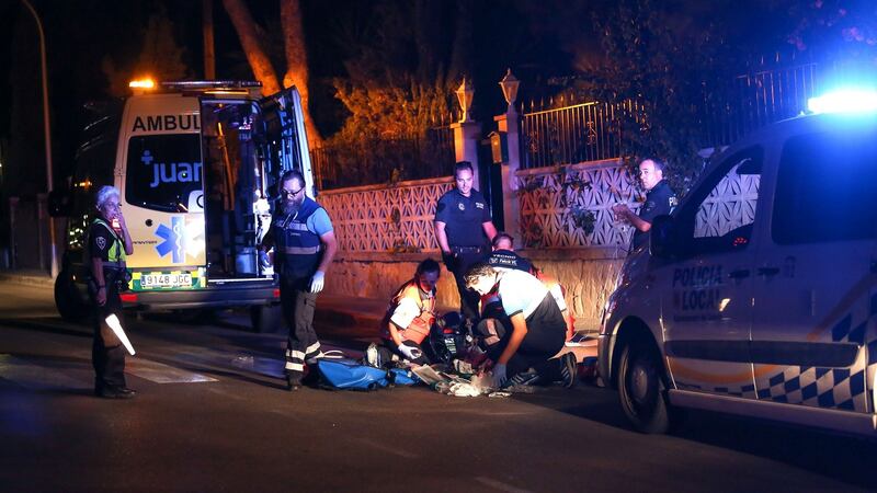 Ambulance staff attend to an Irish man who was shot   on a busy street on the holiday island of Majorca. Photograph: Solarpix