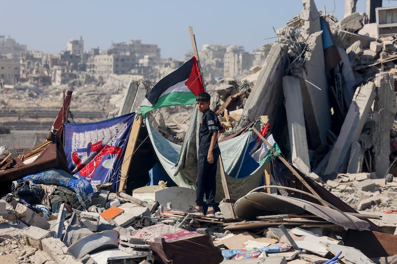 A boy hangs a Palestinian flag in Khan Younis. Photograph: Getty Images         