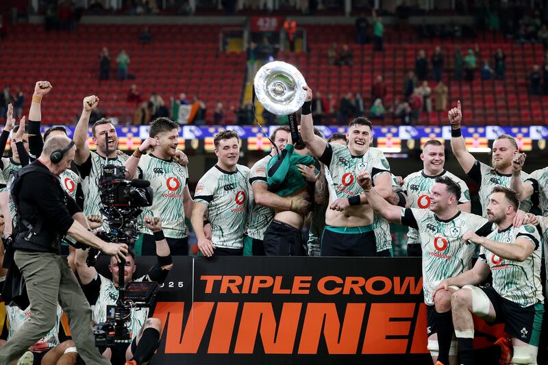 Ireland players celebrate their Triple Crown win in Cardiff. Photograph: Michael Steele/Getty Images