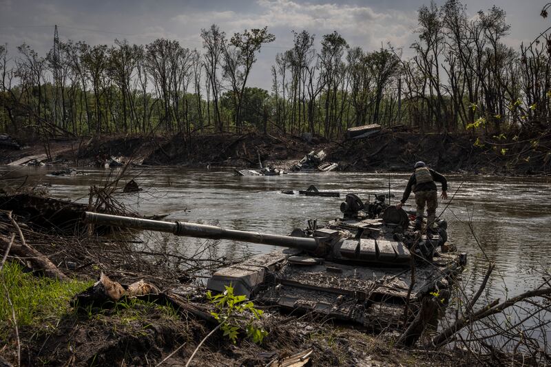A Ukrainian soldier on an abandoned Russian tank in the Siversky Donets river, in Bilohorivka, Ukraine, in May. The river was also on the  front line during the second World War. Photograph: Ivor Prickett/New York Times
                      