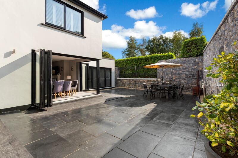 A paved south facing courtyard lies to the rear