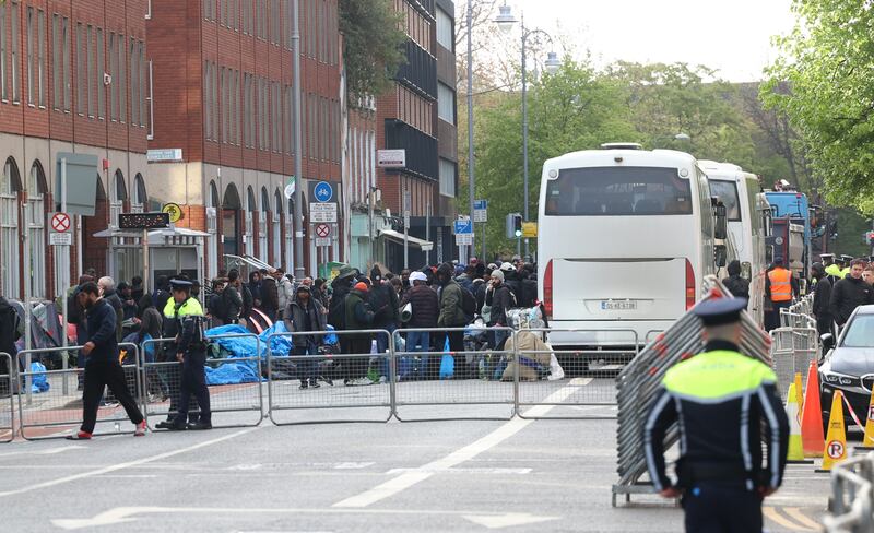 Asylum seekers board buses out of the city centre. Photograph: Sam Boal/Collins Photos