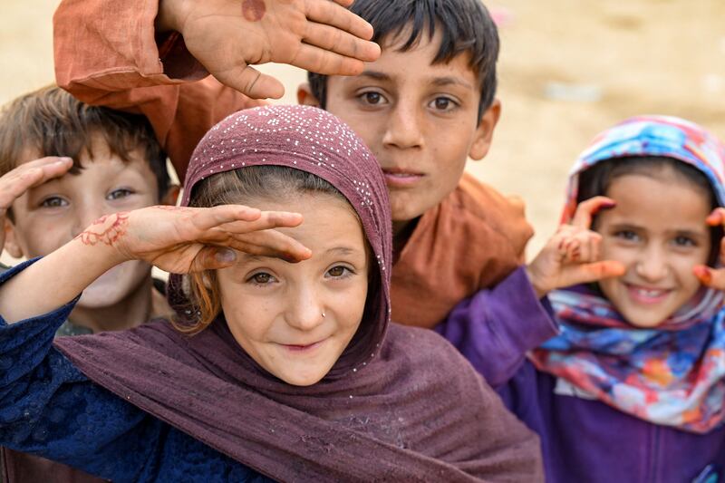 Afghan refugee children gesture as they prepare to depart for Afghanistan. Photograph: Farooq Naeem/AFP/Getty