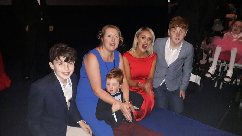 The Adams-Kelly family: Arthur, Kierra, Alister and William, with (in red) Marissa Carter