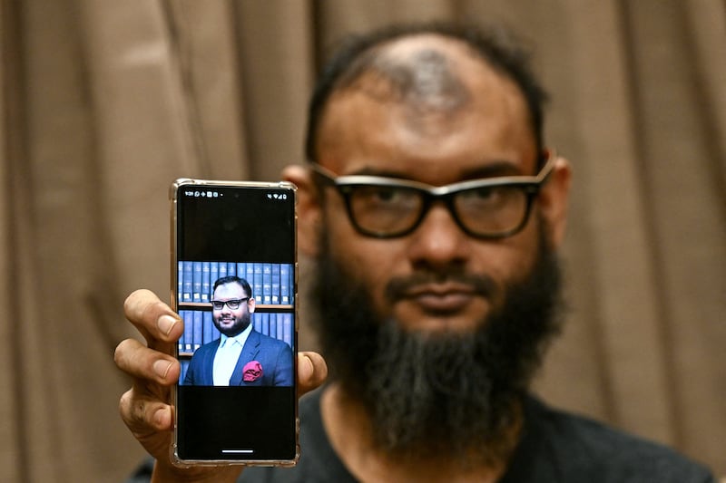 Opposition activist Mir Ahmad bin Quasem is pictured after his release in August 2024 holding a phone with a photo of himself from eight years earlier. Photograph: Indranil Mukherjee/Getty