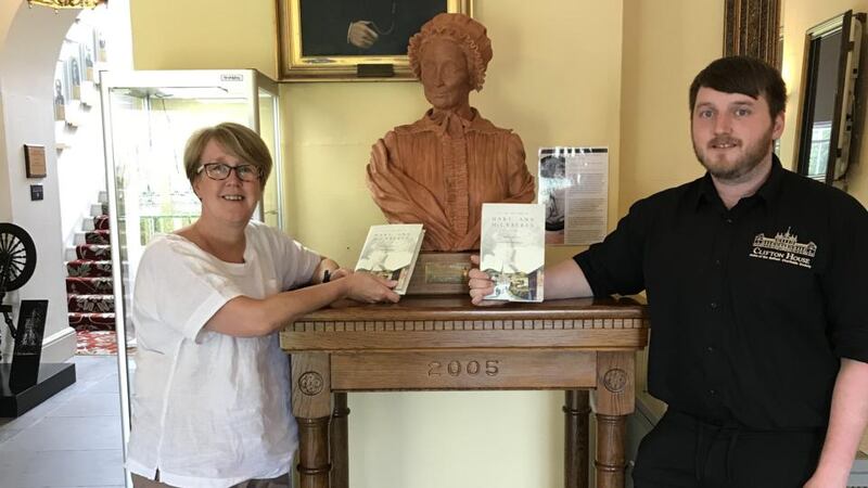 Paula Reynolds, chief executive of Belfast Charitable Society, with archive officer Aaron McIntyre in front of the bust of Mary Ann McCracken. Photograph: Belfast Charitable Society
