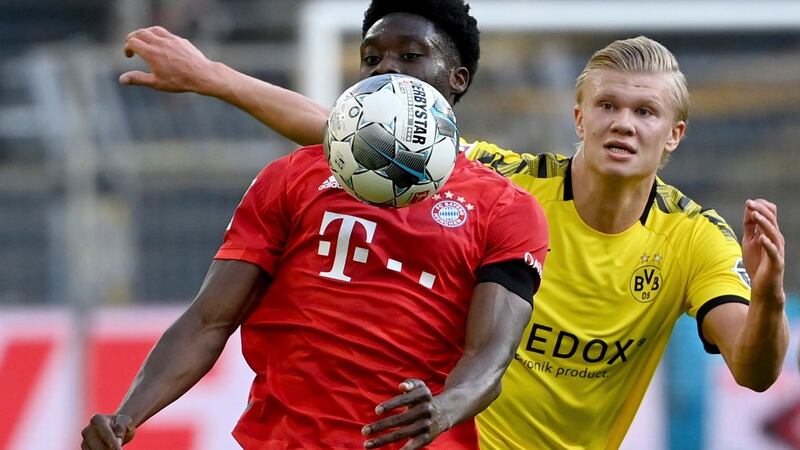 Bayern Munich’s Alphonso Davies holds off Borussia Dortmund’s Erling Haaland. Photograph: Federico Gambarini/PA