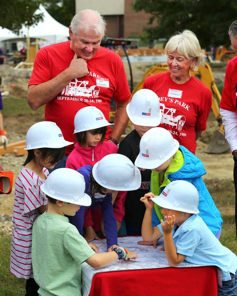 Students from the Winn Brook Elementary School, with blueprints for the playground they helped to design, in front of Joe and Kathy O’Donnell at the start of building for a new playground named for Joey O’Donnell who died in 1986 from Cystic Fibrosis. Photograph: John Tlumacki/The Boston Globe via Getty Images
