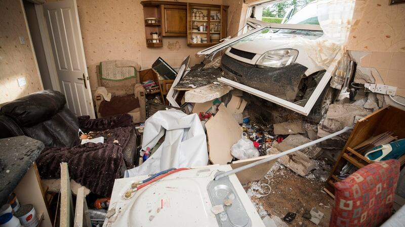 The scene where a van has crashed through the kitchen window of pensioner Annie Burrell’s home outside Waringstown, in County Down. Photograph:  Liam McBurney/PA Wire
