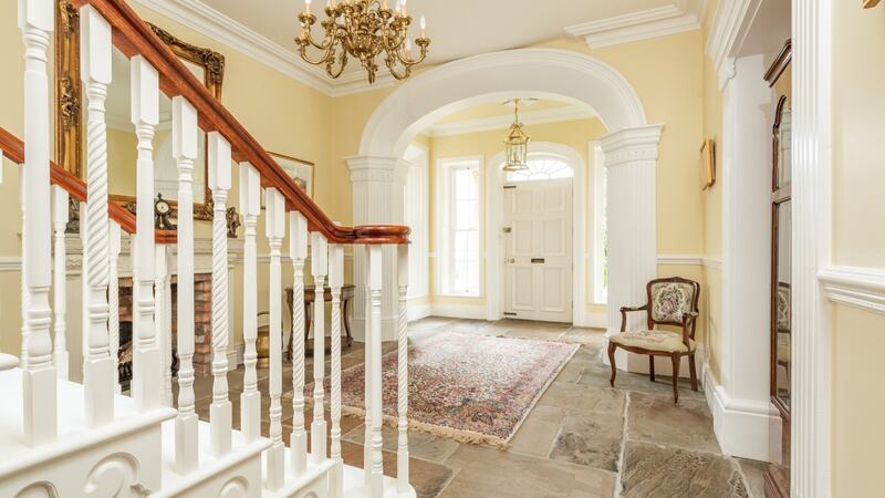 The front door opens into a flagstone-floored vestibule and entrance hall with the drawing room to the left and a sitting room to the right.