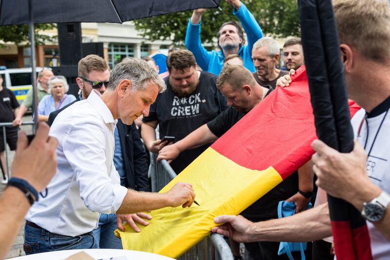 Björn Höcke signs a German flag in Apolda, eastern Germany: On September 1st, Thuringia – and neighbouring Saxony – could trigger a dramatic shift in post-unification German politics. Photograph: Jens Schlueter 