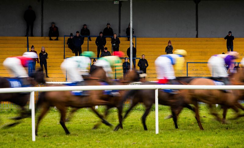 Spectators watch a handicap steeplechase at Thurles in March 2020. Photograph: Ryan Byrne/INPHO