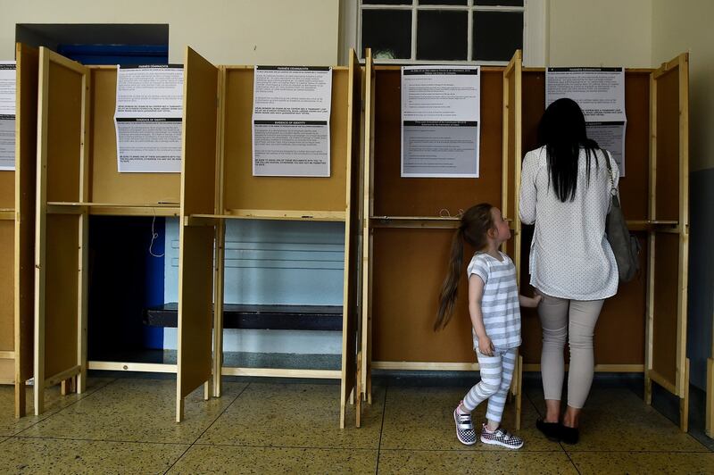 A woman casts her vote with her daughter in a polling station on the day of the abortion referendum  in Dublin on May 25th, 2018. Photograph: Clodagh Kilcoyne/Reuters