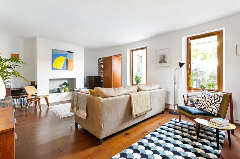 The livingroom is sectioned according to two large windows that overlook the garden.