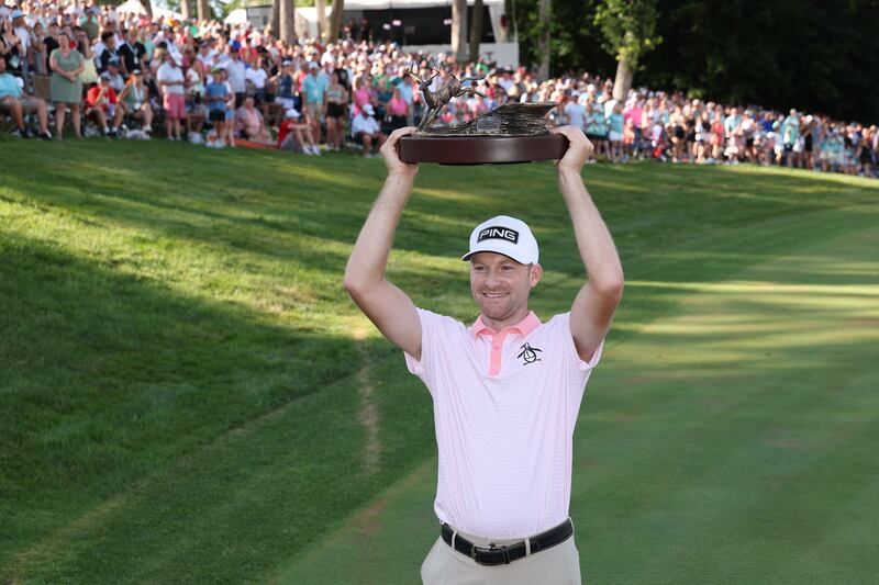 Brian Campbell celebrates with the trophy after winning the John Deere Classic 2025 at TPC Deere Run on July 6th in Silvis, Illinois. Photograph: David Berding/Getty Images